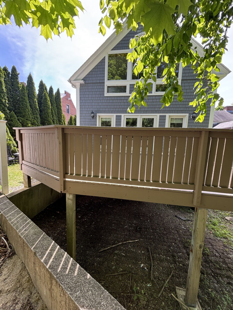 Residential elevated deck refinish from yard perspective — Pepperell MA, Cramb Painting Co.