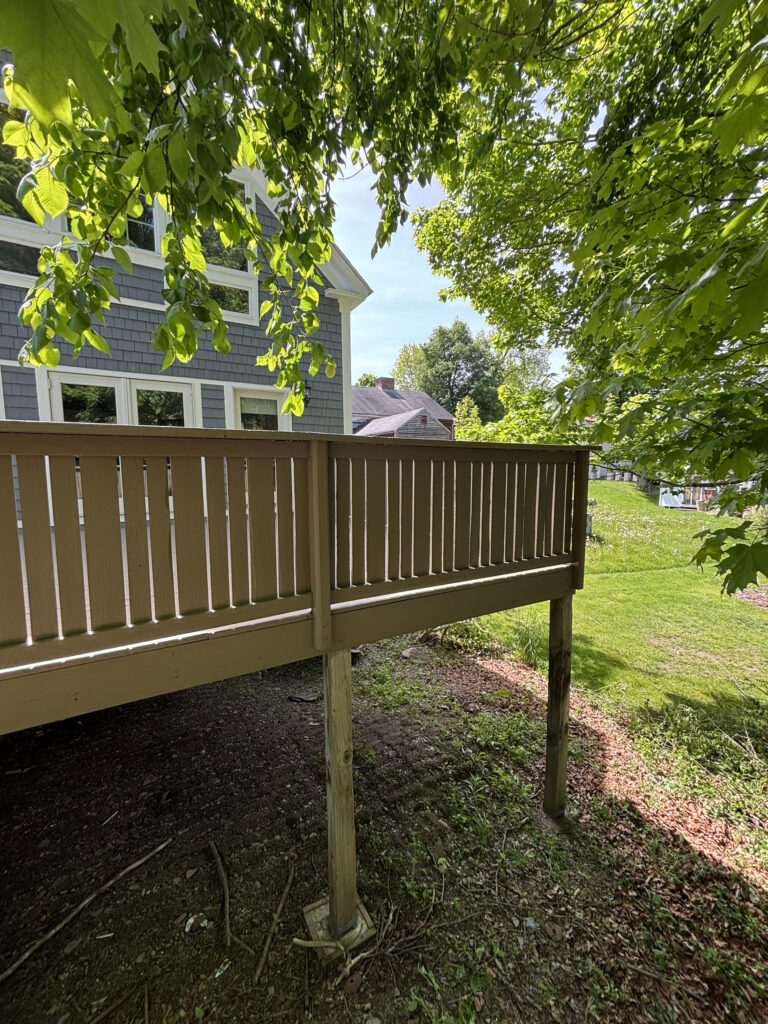 Refinished deck railing and house exterior — Pepperell MA deck restoration by Cramb Painting Co.