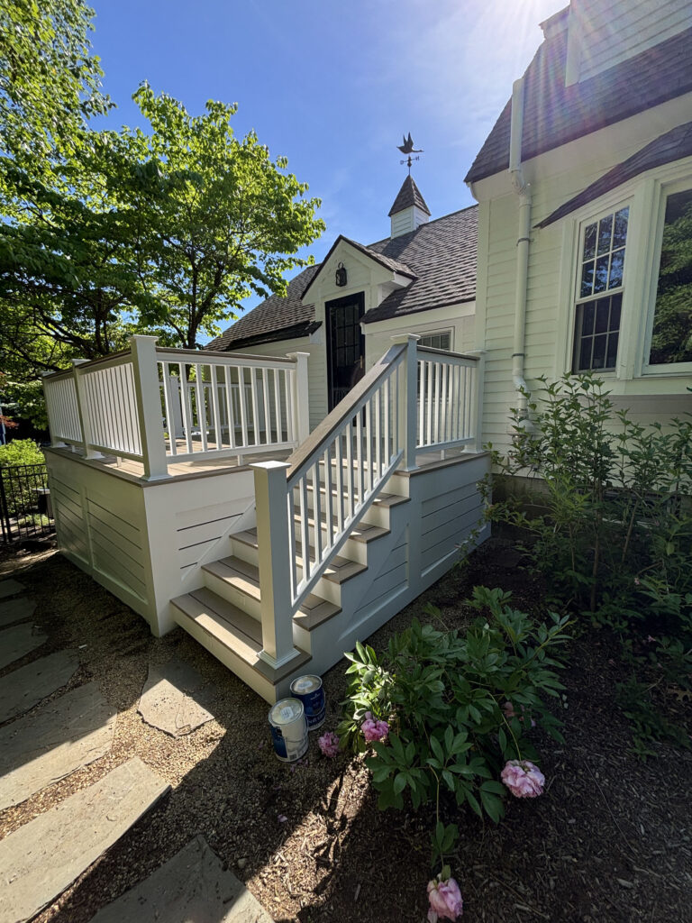 Hopkinton deck refinishing close-up showing stairs, handrail and new protective deck stain by Cramb Paint Co.
